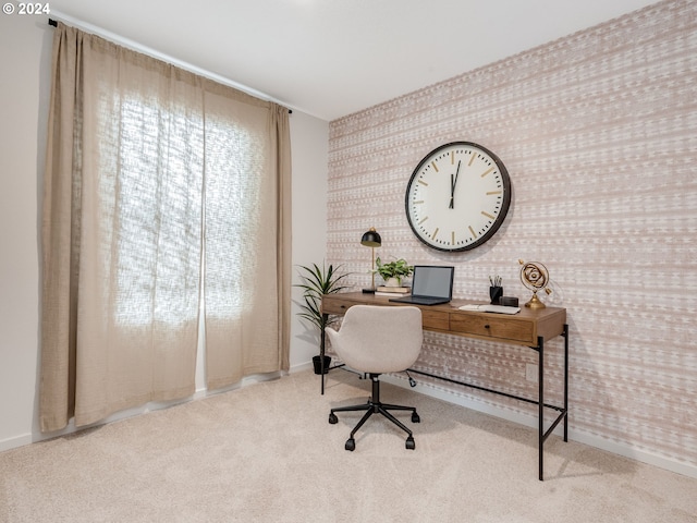 office space featuring light carpet, wallpapered walls, and baseboards