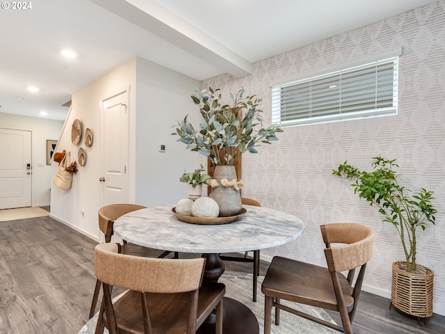 dining space with wallpapered walls, baseboards, dark wood-style floors, beam ceiling, and recessed lighting