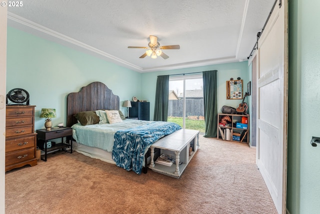 bedroom with a barn door, access to outside, carpet, and a textured ceiling