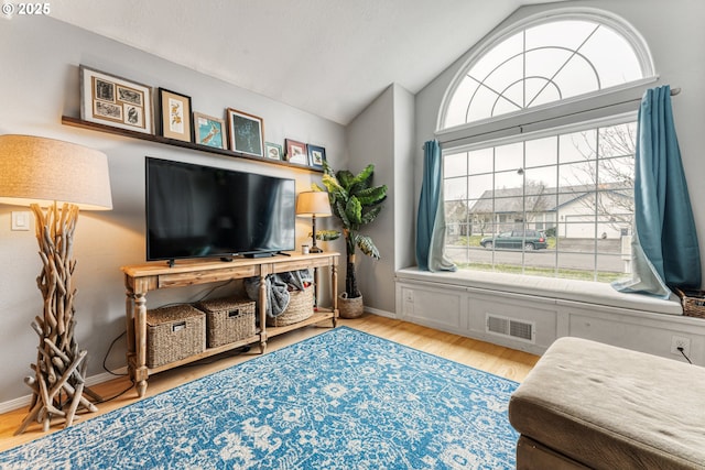 sitting room with vaulted ceiling and light wood-type flooring