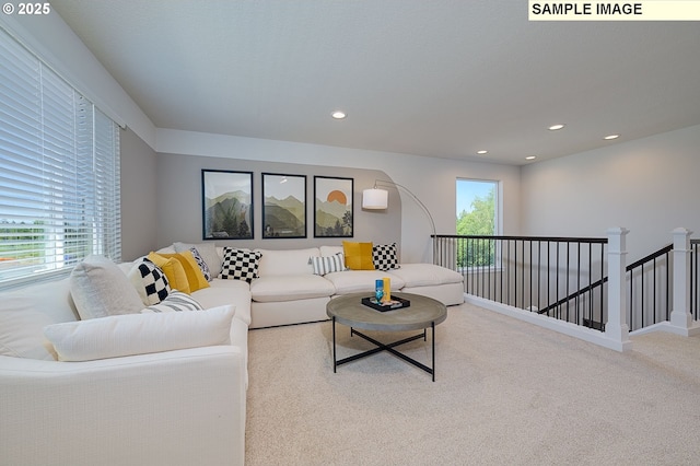 living room with carpet flooring and plenty of natural light