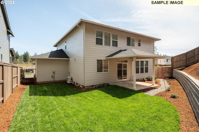 back of property featuring a lawn and a patio