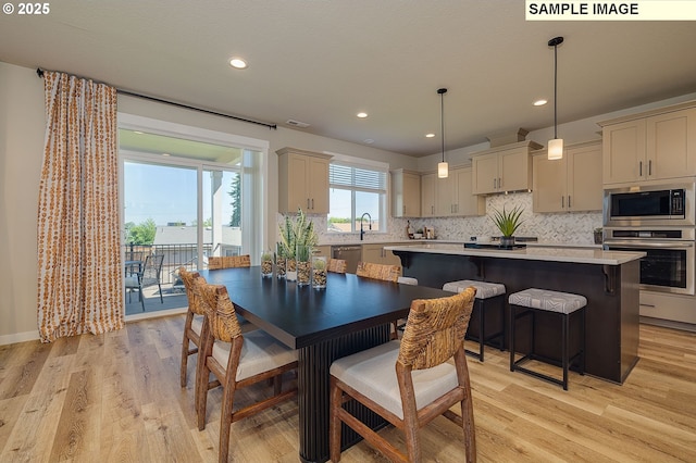 dining room featuring light hardwood / wood-style floors and sink