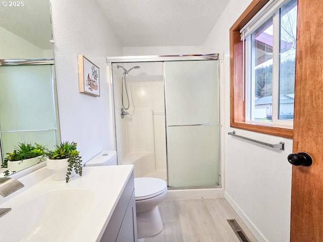 full bathroom featuring visible vents, toilet, a textured ceiling, a shower stall, and vanity