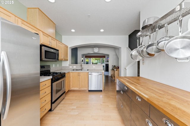 15416 SW Mallard Dr Unit 102, Beaverton, OR 97007 - kitchen featuring appliances with stainless steel finishes, light brown cabinets, arched walkways, light wood-style floors, and recessed lighting
