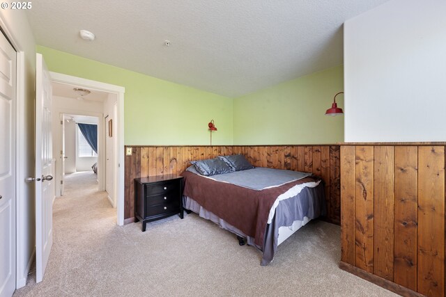 15416 SW Mallard Dr Unit 102, Beaverton, OR 97007 - bedroom featuring wainscoting, carpet, and wooden walls