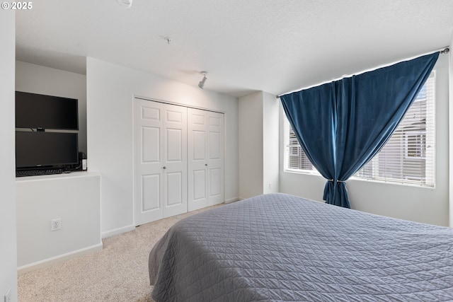 15416 SW Mallard Dr Unit 102, Beaverton, OR 97007 - bedroom featuring carpet, a textured ceiling, a closet, and baseboards