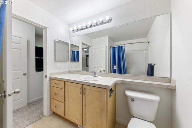 15416 SW Mallard Dr Unit 102, Beaverton, OR 97007 - bathroom featuring vanity, toilet, and a shower with shower curtain