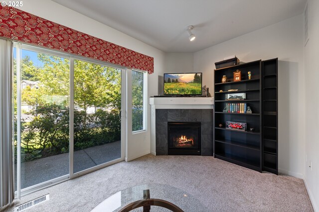 15416 SW Mallard Dr Unit 102, Beaverton, OR 97007 - unfurnished living room featuring carpet, a fireplace, and baseboards