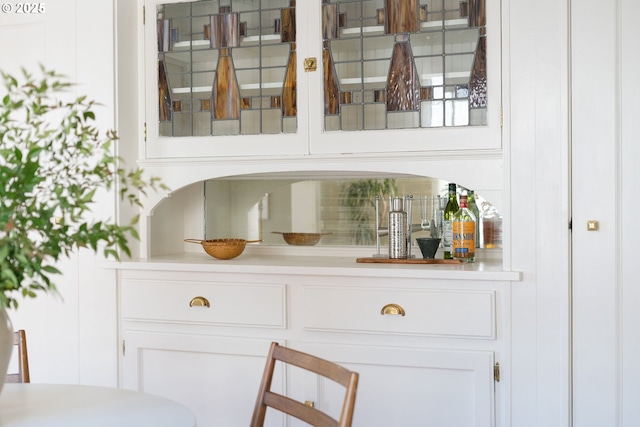 bar featuring white cabinets