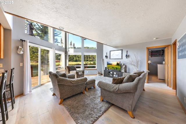 33645 Resort Dr, Pacific City, OR 97135 - living room featuring a textured ceiling, healthy amount of natural light, and light wood-type flooring