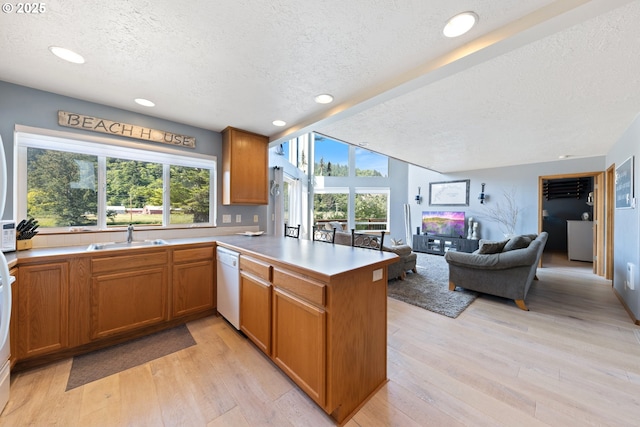 33645 Resort Dr, Pacific City, OR 97135 - kitchen featuring a textured ceiling, white dishwasher, a peninsula, light wood-style flooring, and recessed lighting