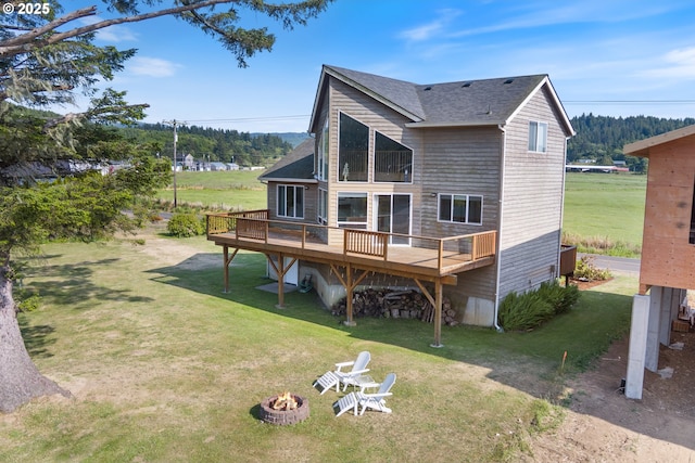 33645 Resort Dr, Pacific City, OR 97135 - rear view of property featuring a fire pit, a deck, a yard, and a shingled roof