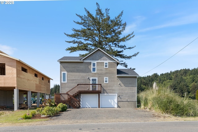 33645 Resort Dr, Pacific City, OR 97135 - view of front facade featuring stairs, driveway, and a garage