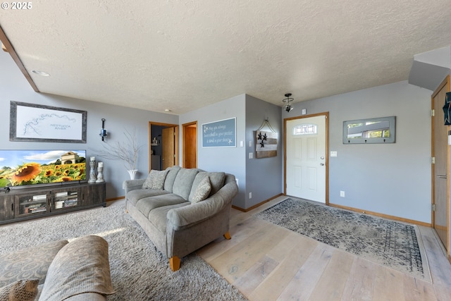33645 Resort Dr, Pacific City, OR 97135 - living area featuring a textured ceiling and light wood-style floors