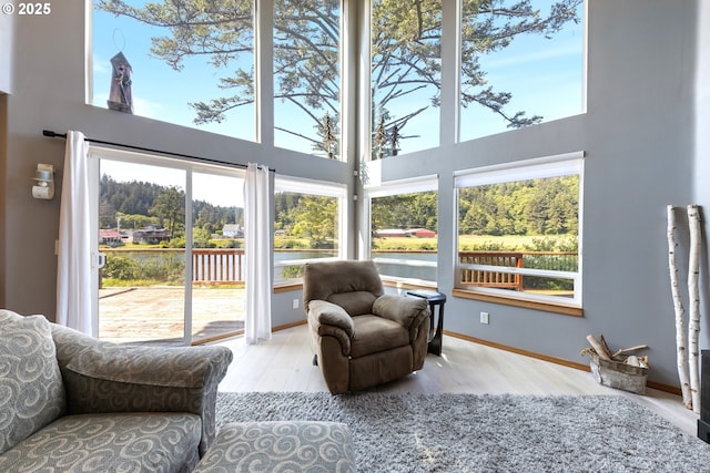 33645 Resort Dr, Pacific City, OR 97135 - sitting room featuring a towering ceiling, plenty of natural light, wood finished floors, and a water view