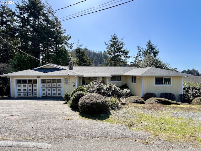 single story home featuring a garage and driveway