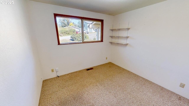 carpeted empty room with visible vents