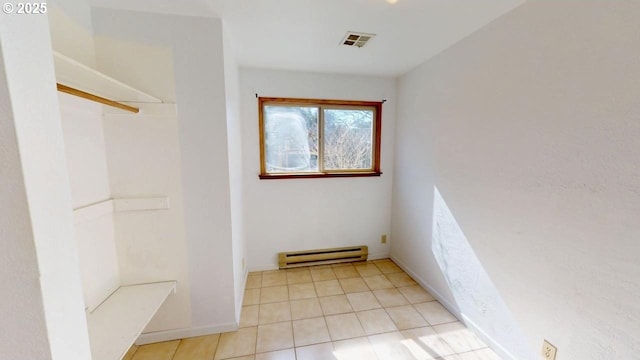 full bath featuring visible vents, a baseboard heating unit, baseboards, walk in shower, and tile patterned floors