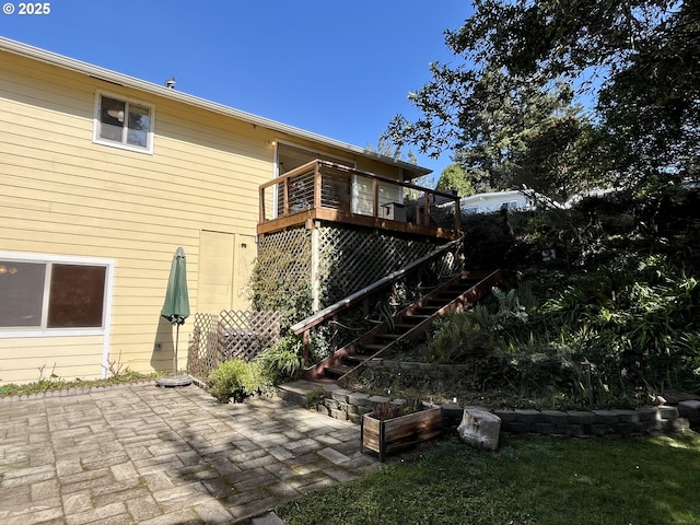 back of house with a deck, stairs, and a patio area