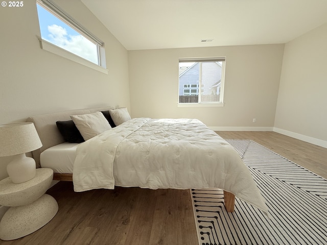 8015 NE 172nd Ave, Vancouver, WA 98682 - bedroom featuring light wood finished floors, multiple windows, and baseboards
