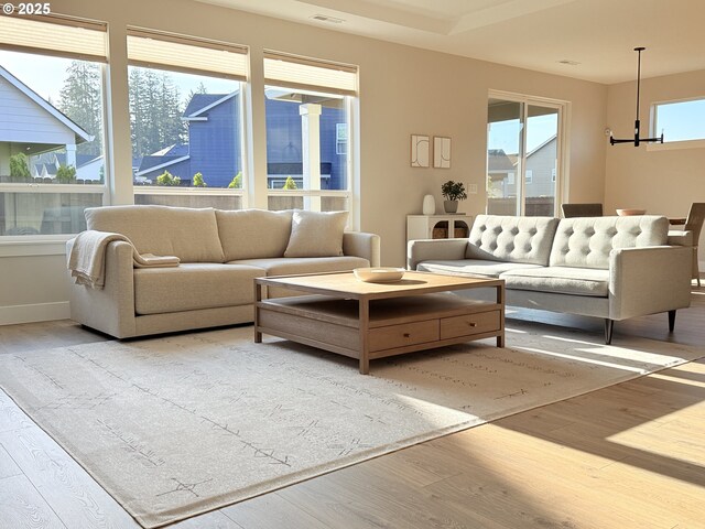 8015 NE 172nd Ave, Vancouver, WA 98682 - living area featuring wood finished floors, a chandelier, and baseboards