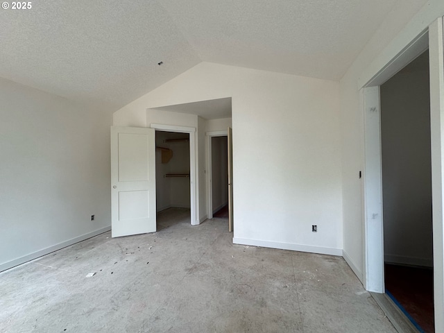 407 SE Shetterly Dr, Dallas, OR 97338 - unfurnished bedroom featuring lofted ceiling and a textured ceiling