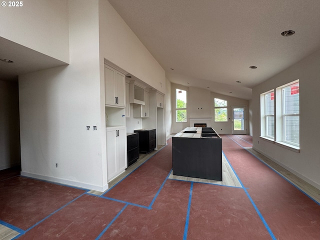 407 SE Shetterly Dr, Dallas, OR 97338 - kitchen featuring open floor plan, vaulted ceiling, and a center island