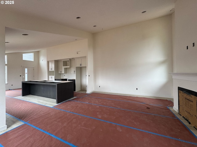 407 SE Shetterly Dr, Dallas, OR 97338 - unfurnished living room featuring a fireplace and a towering ceiling