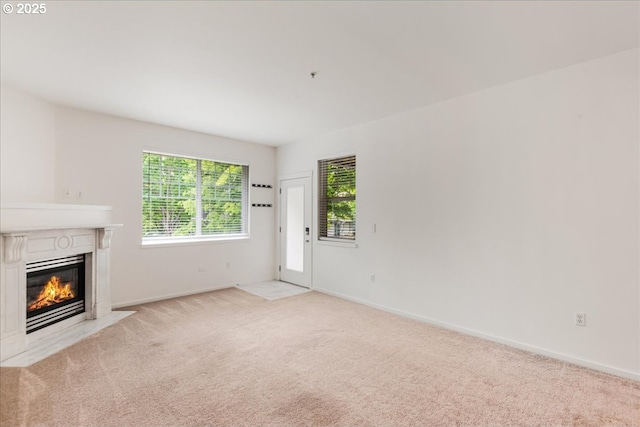 10800 SE 17th Cir Unit Q178, Vancouver, WA 98664 - unfurnished living room with a fireplace with flush hearth, light colored carpet, and baseboards