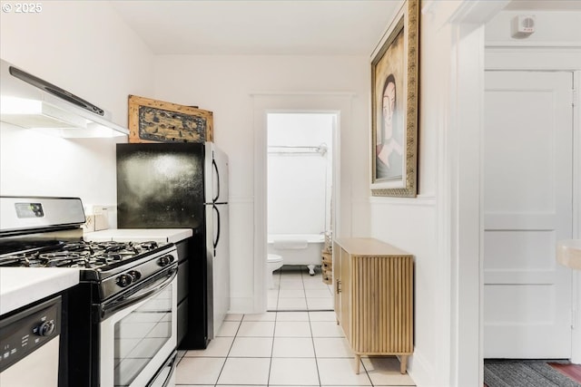 kitchen with dishwasher, light tile patterned floors, and stainless steel gas range oven