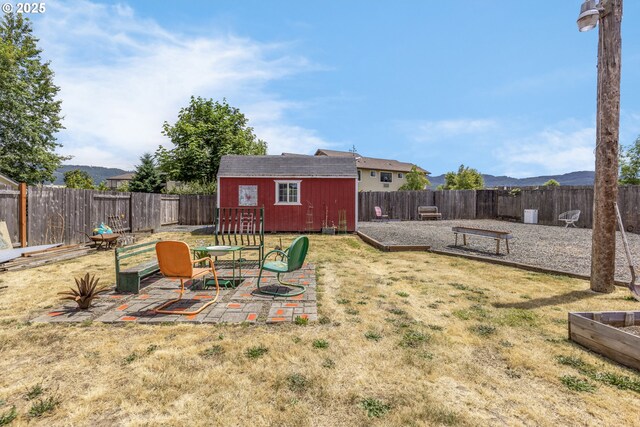 91161 N Miller St, Eugene, OR 97408 - fenced backyard featuring an outdoor structure and a patio