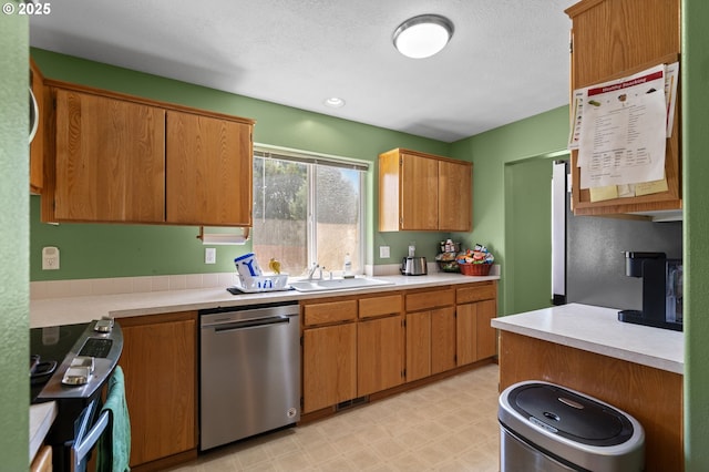 112 NE 11th St, Hermiston, OR 97838 - kitchen with dishwasher, stove, light countertops, a sink, and light floors