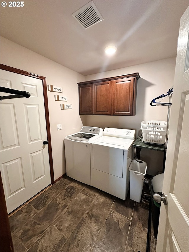 laundry room featuring cabinet space, separate washer and dryer, and visible vents