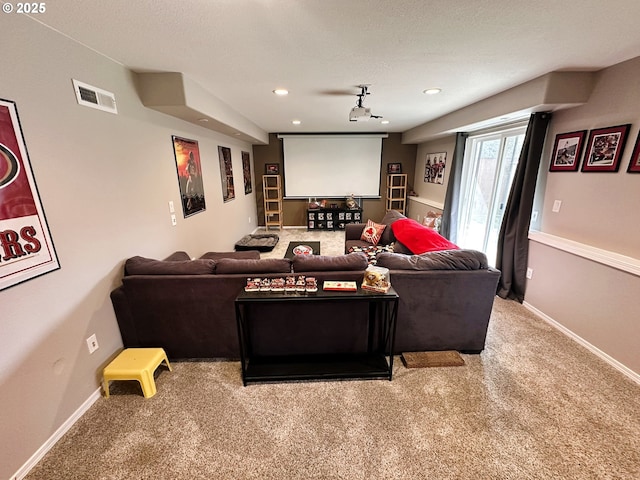 home theater room with visible vents, a textured ceiling, recessed lighting, carpet flooring, and baseboards