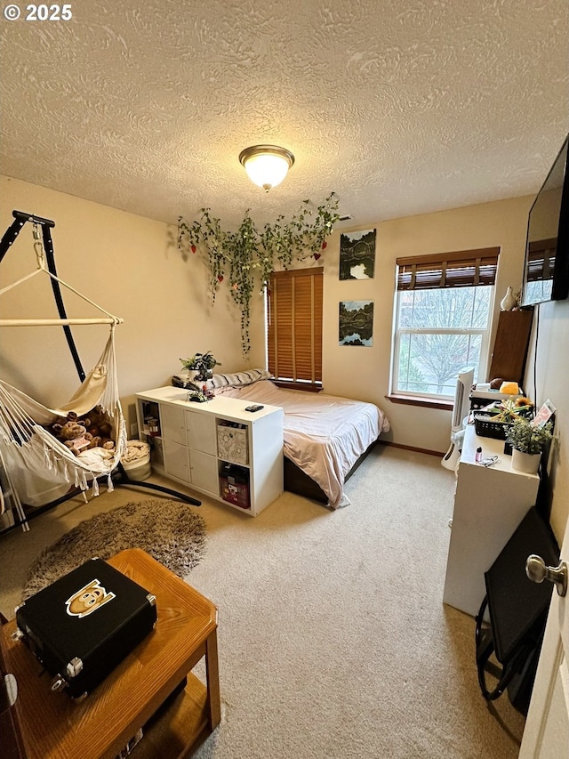 bedroom with a textured ceiling and carpet floors