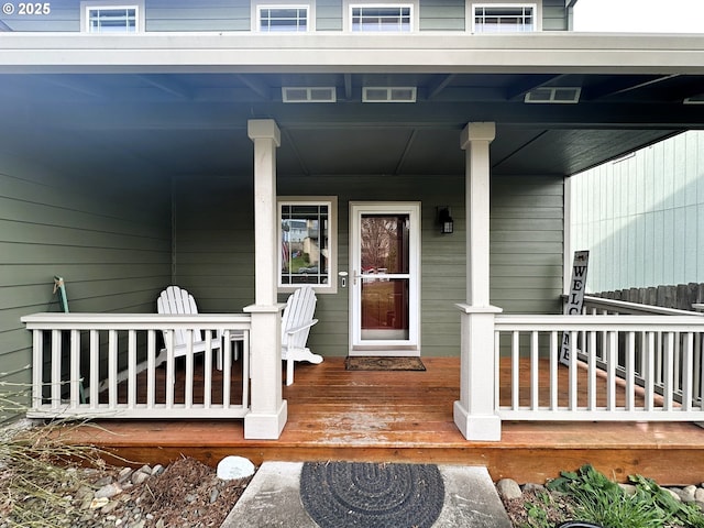 view of exterior entry featuring covered porch