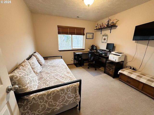 bedroom featuring visible vents, a textured ceiling, and carpet