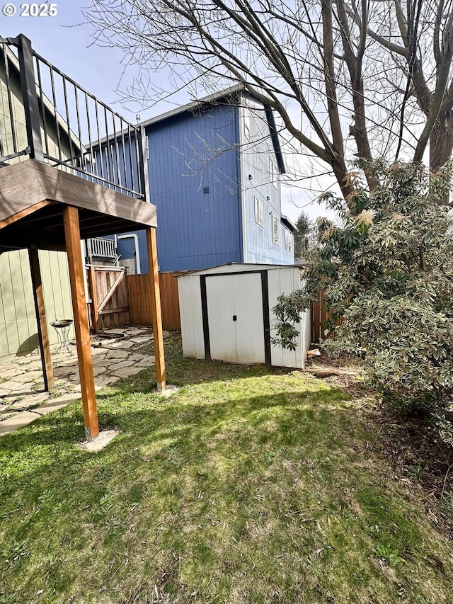 view of shed featuring fence