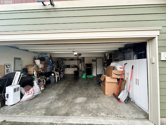 garage featuring electric panel and a garage door opener