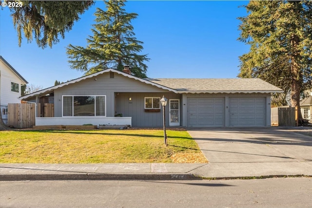 ranch-style house with a garage and a front lawn