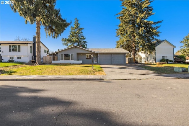 view of front of home featuring a garage and a front lawn