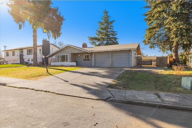 single story home featuring a garage and a front lawn