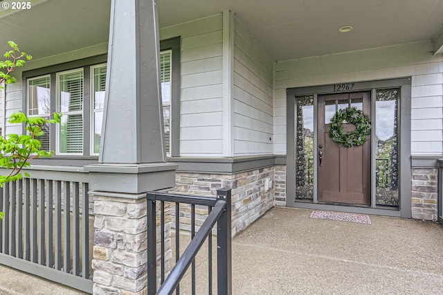 12967 SW River Terrace Blvd, Beaverton, OR 97007 - view of exterior entry with stone siding and a porch