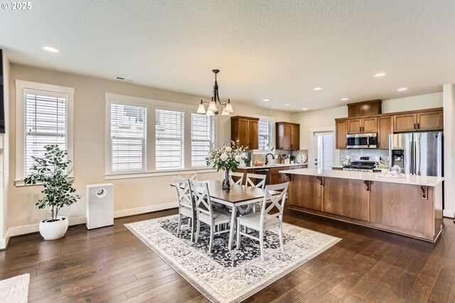 12967 SW River Terrace Blvd, Beaverton, OR 97007 - dining space featuring dark wood-style floors, baseboards, a chandelier, recessed lighting, and a textured ceiling