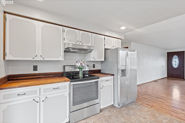 kitchen featuring white cabinetry, light hardwood / wood-style floors, stainless steel appliances, and butcher block countertops