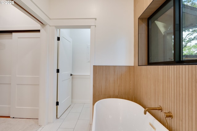 bathroom featuring tile patterned floors and a bathtub