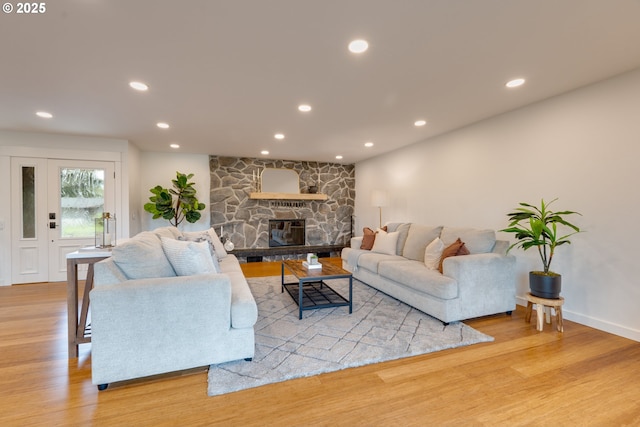 living room featuring a fireplace and light hardwood / wood-style flooring