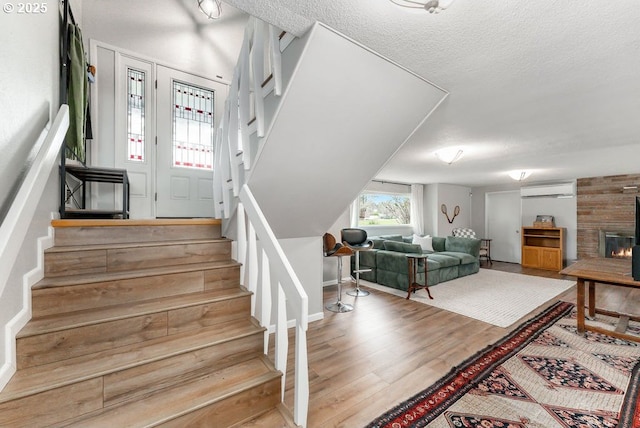 185 W Oriole Dr, Roseburg, OR 97471 - stairs featuring a textured ceiling, a wall unit AC, and wood finished floors