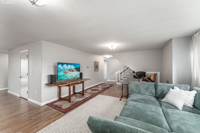 185 W Oriole Dr, Roseburg, OR 97471 - living room featuring a textured ceiling, wood finished floors, baseboards, and stairway